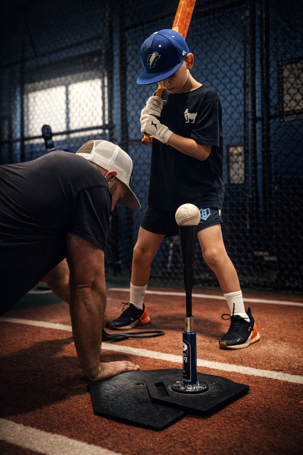 Coach Steve working with Nico on swing mechanics