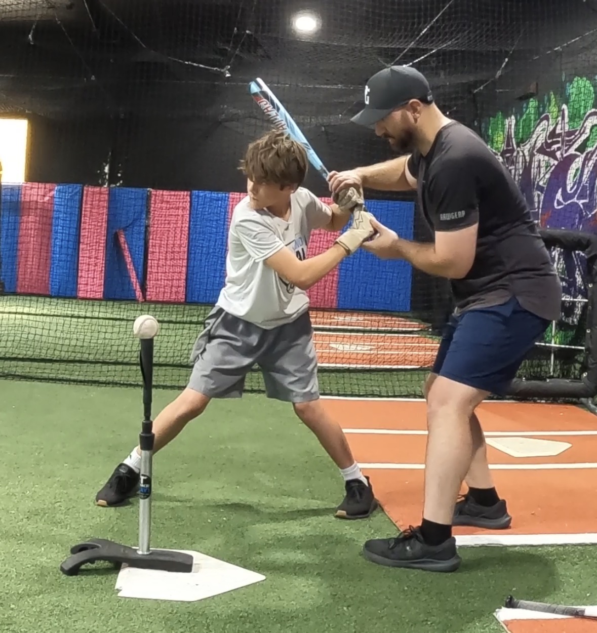 Coach Steve watching a hitter's move through the swing during a private session