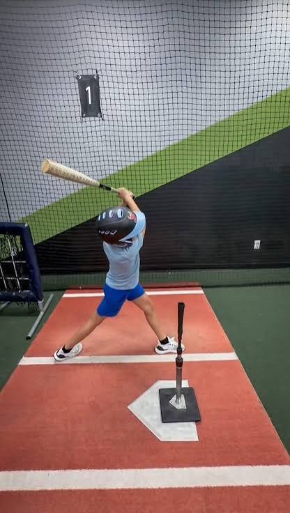 Young man hitting off tee