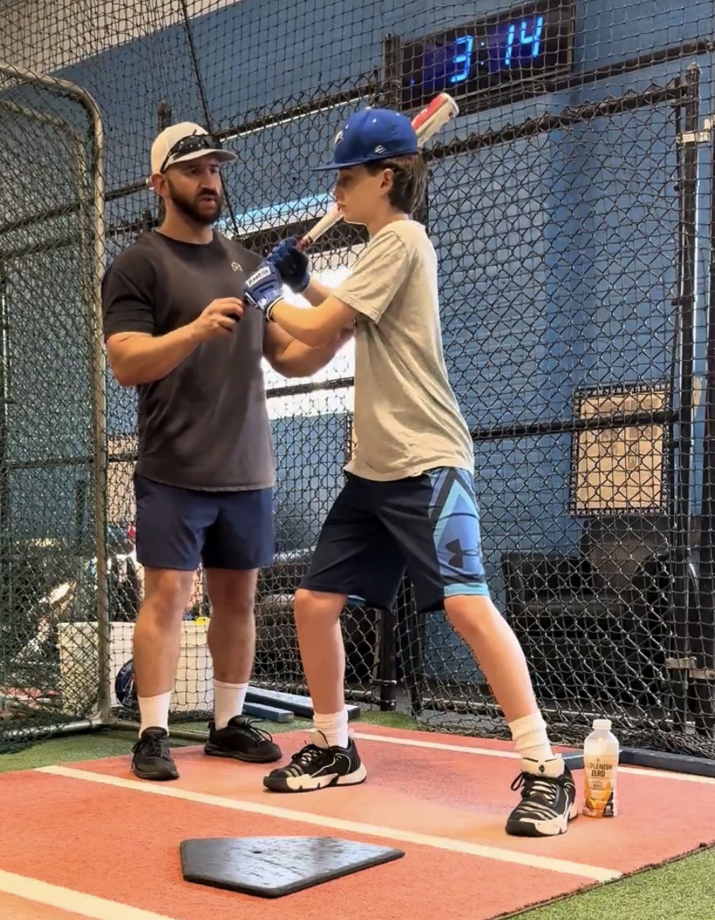 Coach Steve talking through a setup adjustment one-on-one with a hitter in the cage